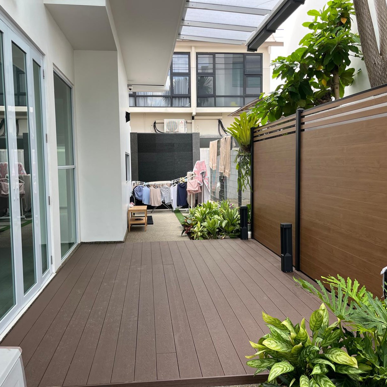 Aluminium wood grain fence panels beside composite decking in Singapore
