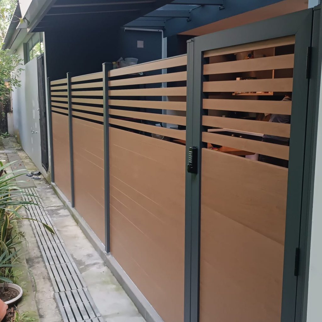 Aluminium slat fence with matching gate at a Singapore landed home