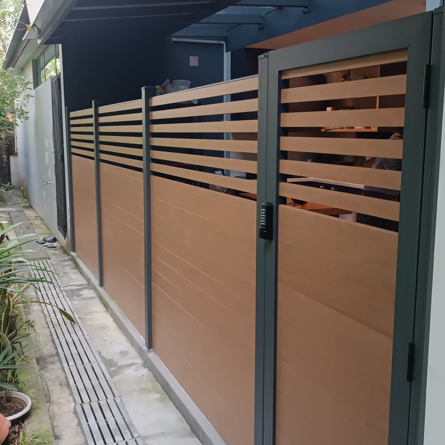 Aluminium slat fence with matching gate at a Singapore landed home